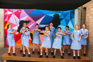 Group of students dancing on stage