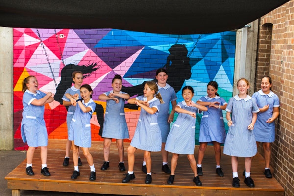 Group of students dancing on stage