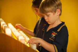 Student inside church turning on candle